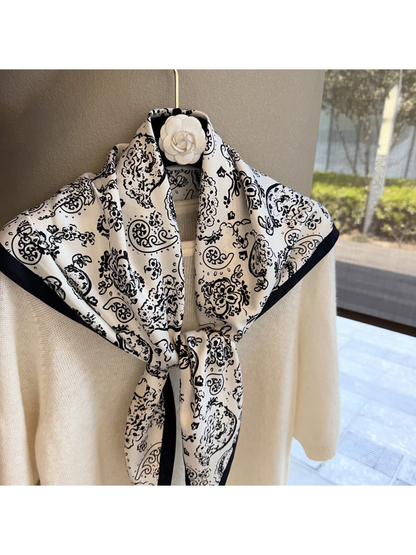Close-up of the White scarf's paisley pattern and dark border
