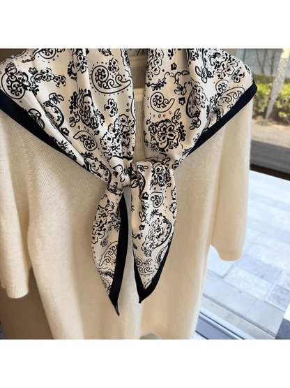 Close-up of the White scarf's tied ends and contrasting dark edge