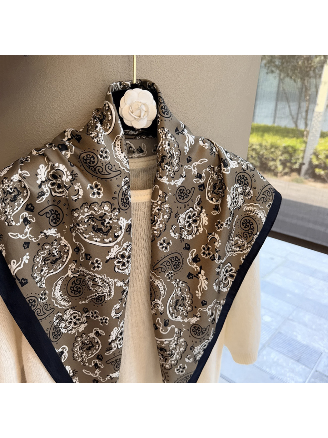 Close-up of the Khaki scarf's paisley pattern and dark border