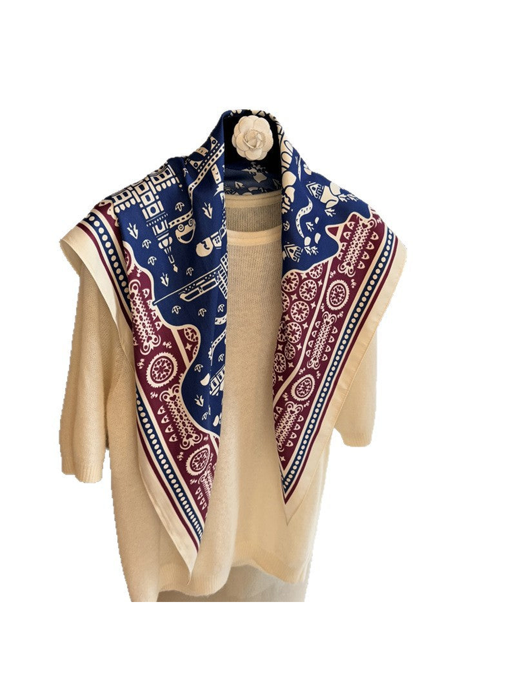 Navy, burgundy and ivory patterned scarf draped over a cream top