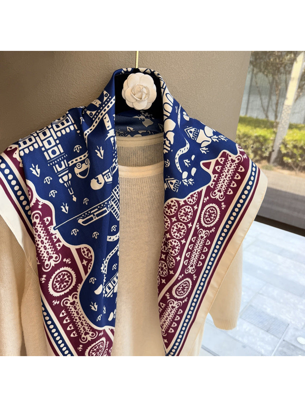 Close-up of navy and burgundy architectural and paisley motifs on the scarf