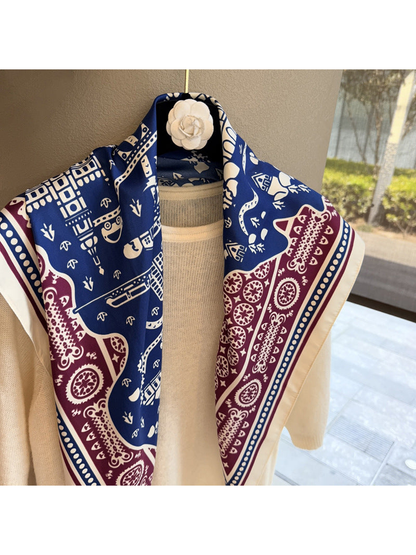 Close-up of navy and burgundy architectural and paisley motifs on the scarf