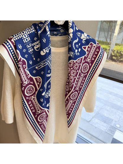 Close-up of the scarf's ivory border and dotted navy inner stripe