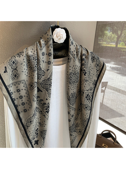 Close-up of the gray scarf's paisley and medallion pattern