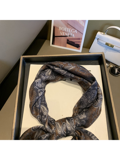 Close-up of the paisley scarf arranged around a loose knot