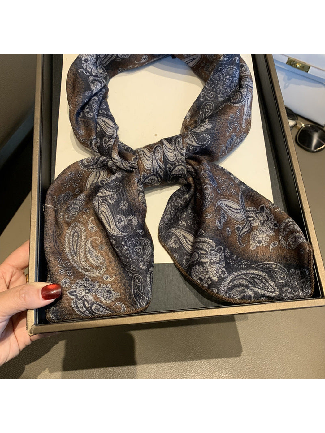 Close-up of the scarf knot, patterned ends and stitched edges