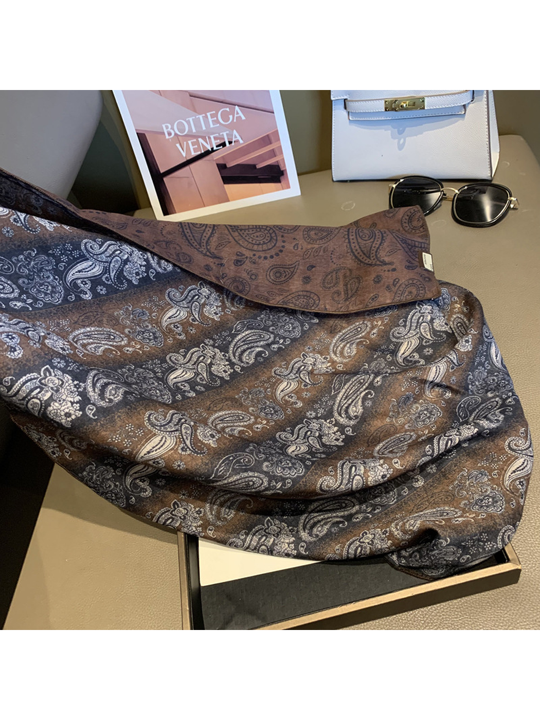 Draped scarf detail showing the striped paisley front and contrasting reverse