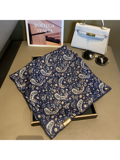 Navy square scarf spread out to show the paisley and floral pattern
