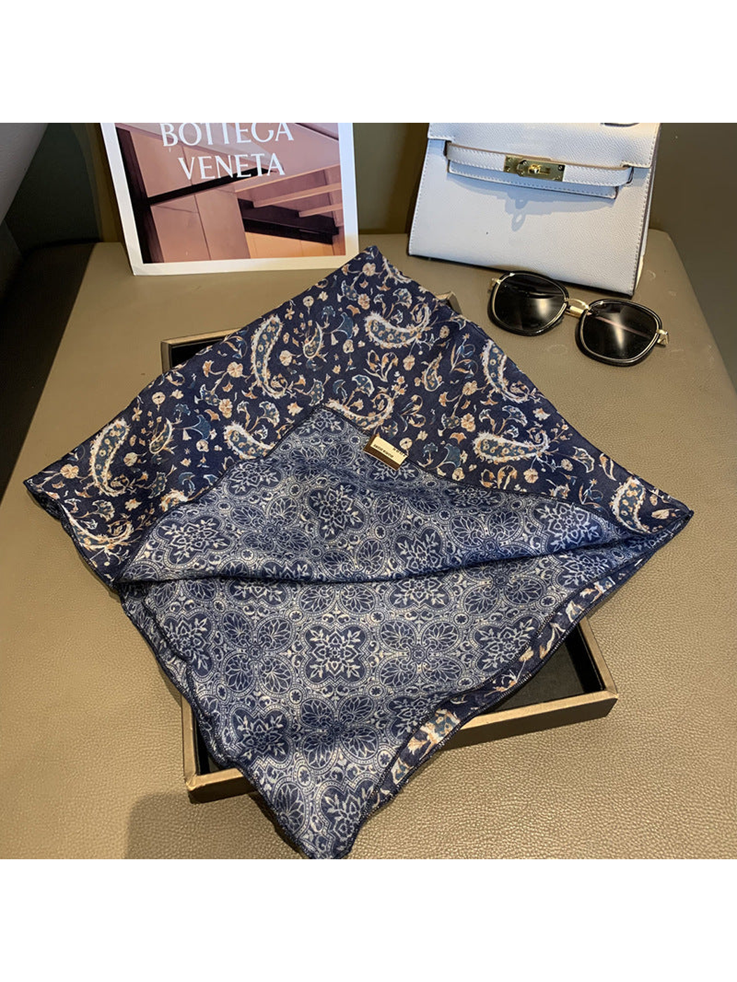 Close-up of the Navy scarf's paisley face and medallion-patterned reverse