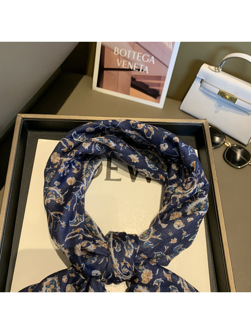 Close-up of the Navy scarf knot and fine woven-look texture