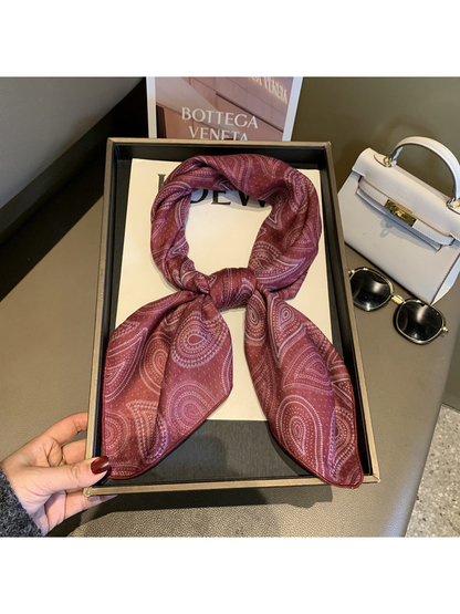 Burgundy paisley scarf tied in a loop with draped ends