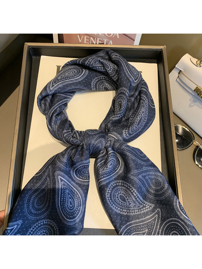 Close-up of the Navy scarf's paisley pattern and tied center