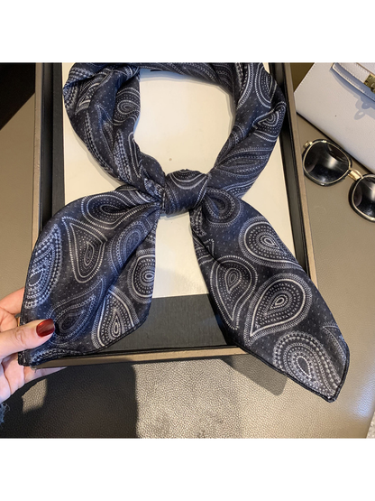 Close-up of the Black scarf's paisley pattern and narrow stitched edge