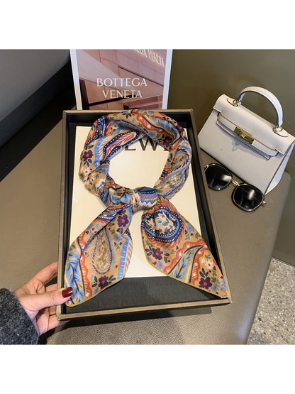 Beige paisley and floral square scarf tied in a loop