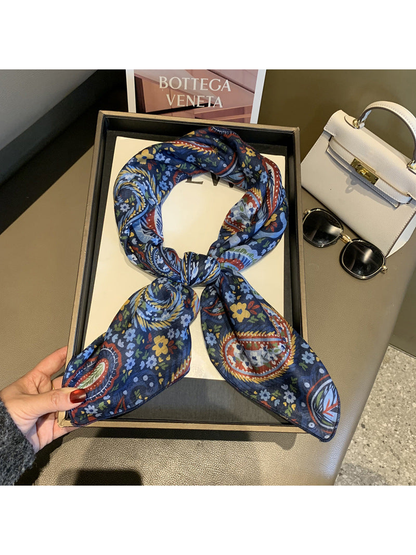 Navy paisley and floral square scarf tied in a loop
