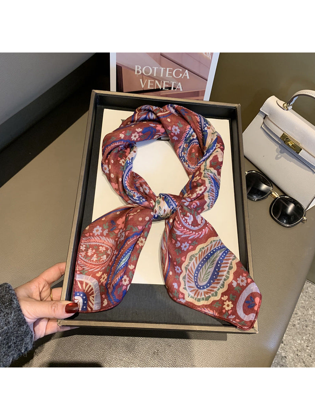 Red paisley and floral square scarf tied in a loop