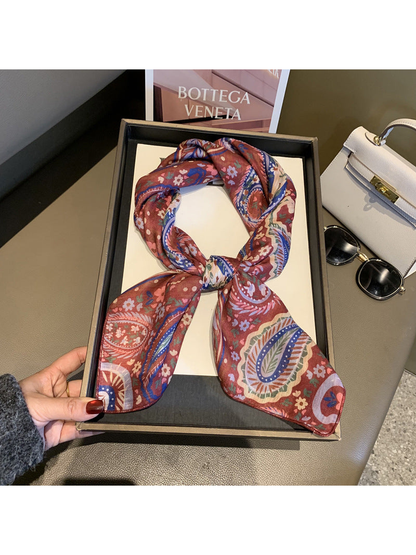 Red paisley and floral square scarf tied in a loop