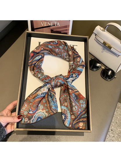 Brown paisley and floral square scarf tied in a loop