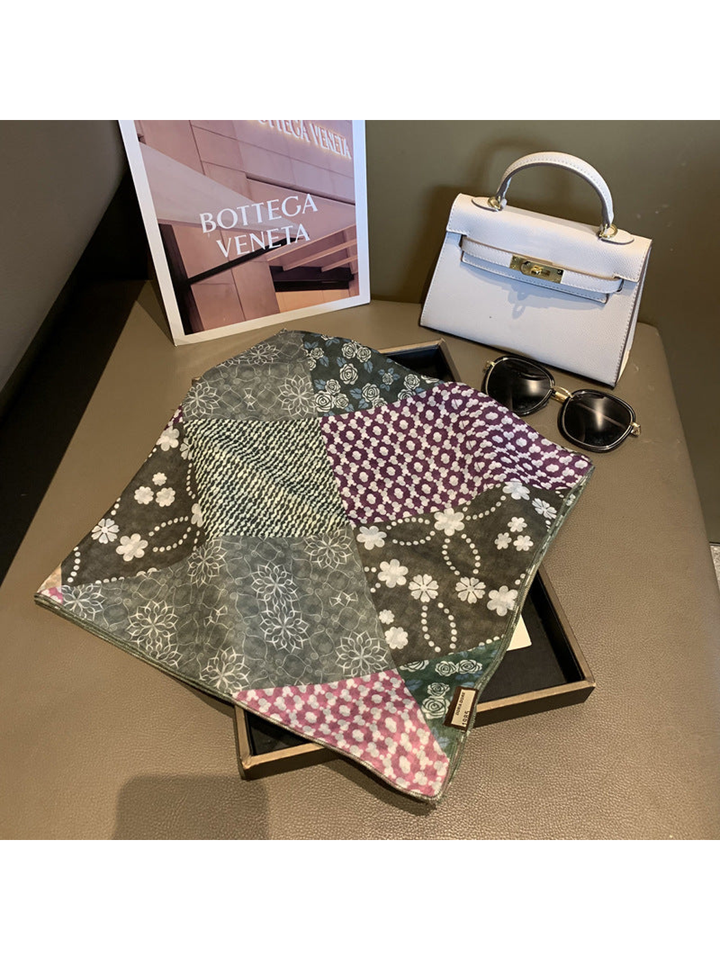 Green square scarf laid flat to show the floral, dotted and striped patchwork pattern