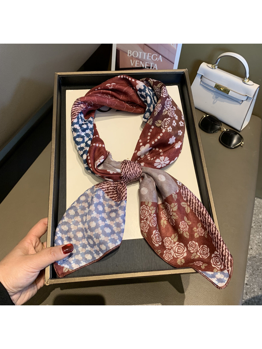 Red floral patchwork scarf tied in a loose knot, full view
