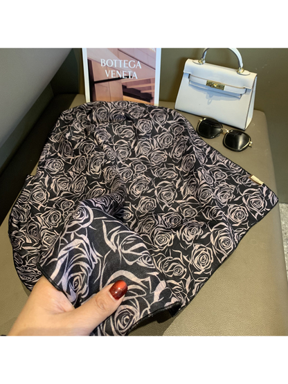 Close-up of the black scarf's rose pattern, reverse side and stitched edge
