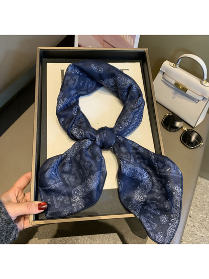 Navy paisley scarf tied in a looped knot