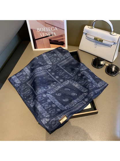 Navy square scarf opened to display the framed paisley pattern