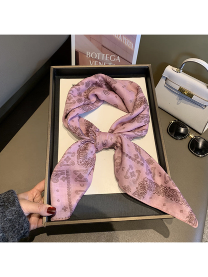 Light Pink paisley scarf tied in a looped knot