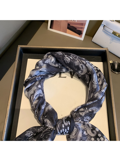 Close-up of the black and gray paisley pattern around the scarf loop