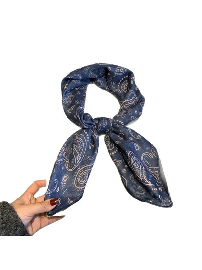 Navy paisley scarf tied in a loop on a white background