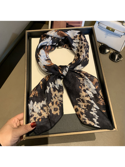 Black, tan and cream animal-print scarf styled in a loose neck tie