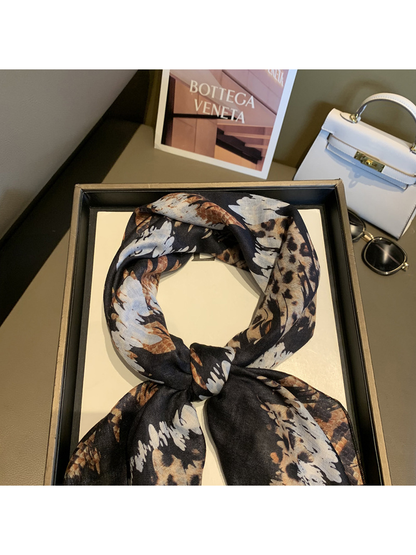 Close-up of the tied scarf showing the mixed animal-print pattern