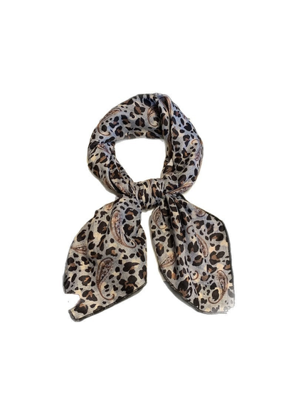 Gray leopard and paisley scarf tied against a white background