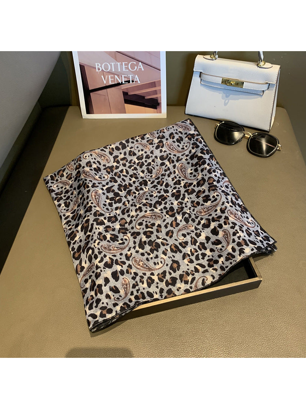 Gray square scarf with leopard and paisley print, folded flat