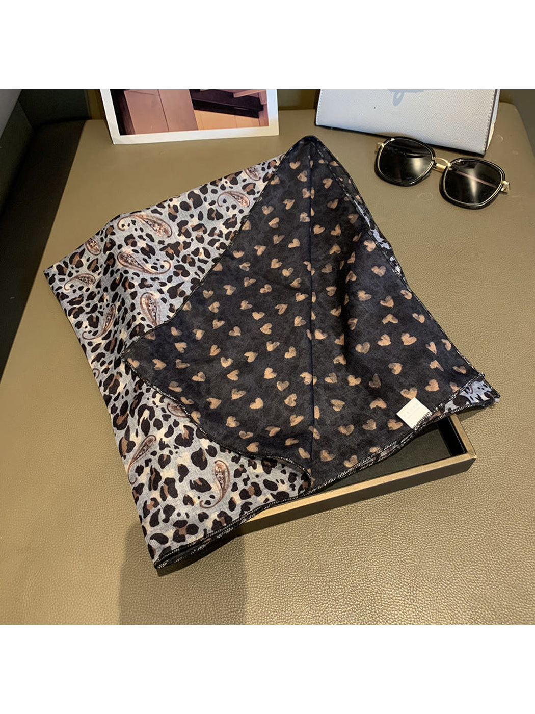 Close-up of the scarf's gray printed face and contrasting dark reverse