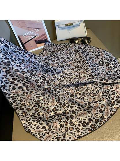 Gray square scarf spread out to show the leopard and paisley pattern