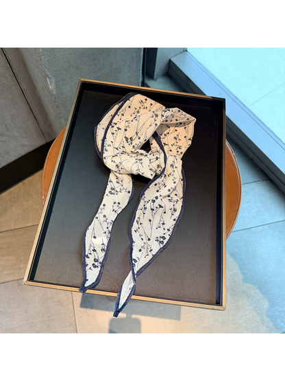 Navy floral triangle scarf arranged in a loose knot