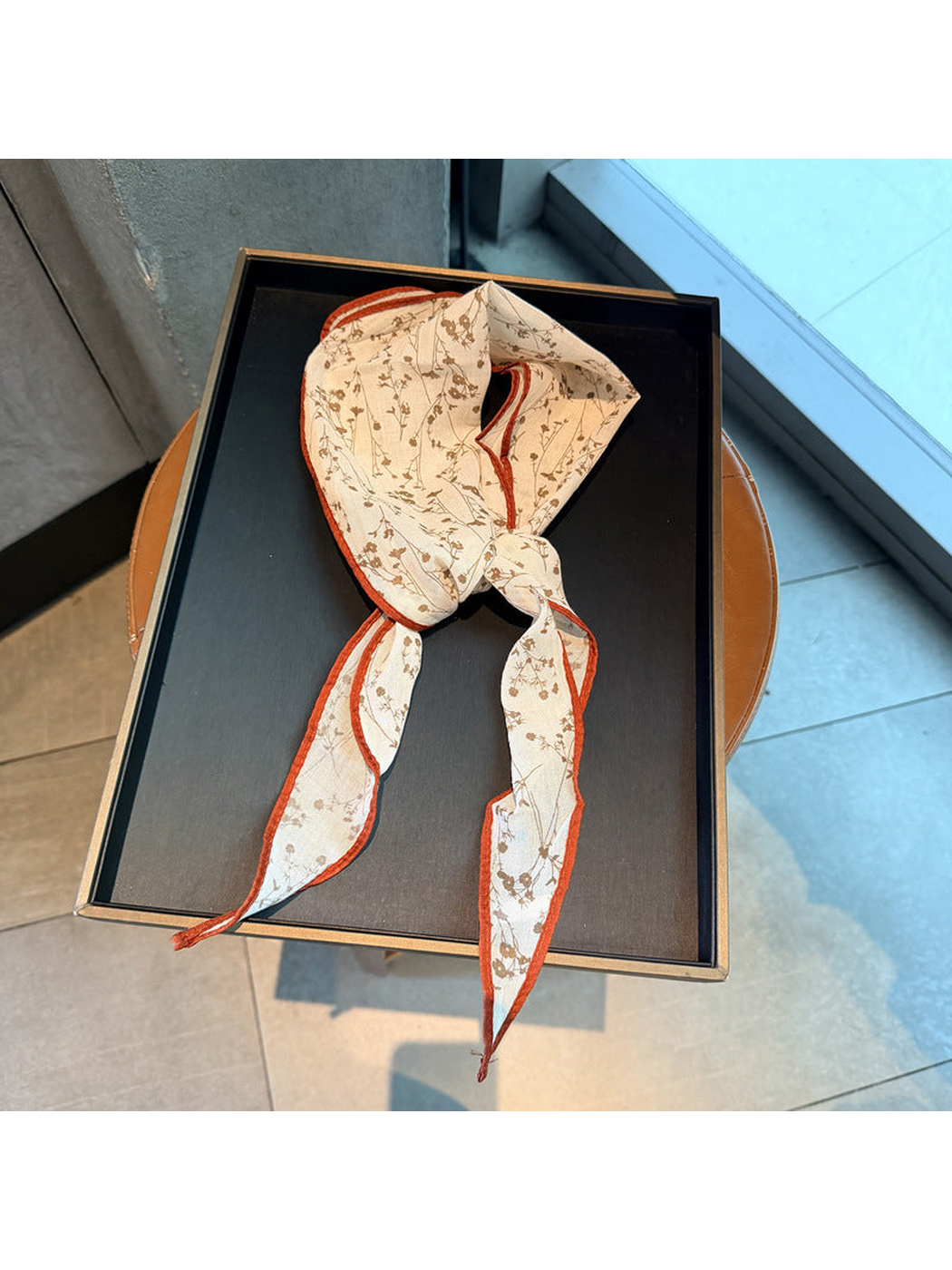 Orange Red floral triangle scarf arranged in a loose knot
