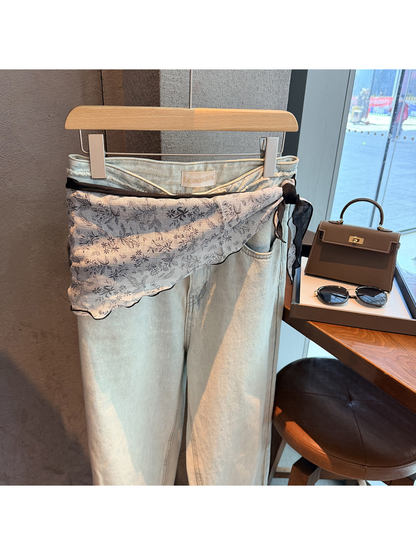 White Black botanical triangle scarf tied around light-wash jeans