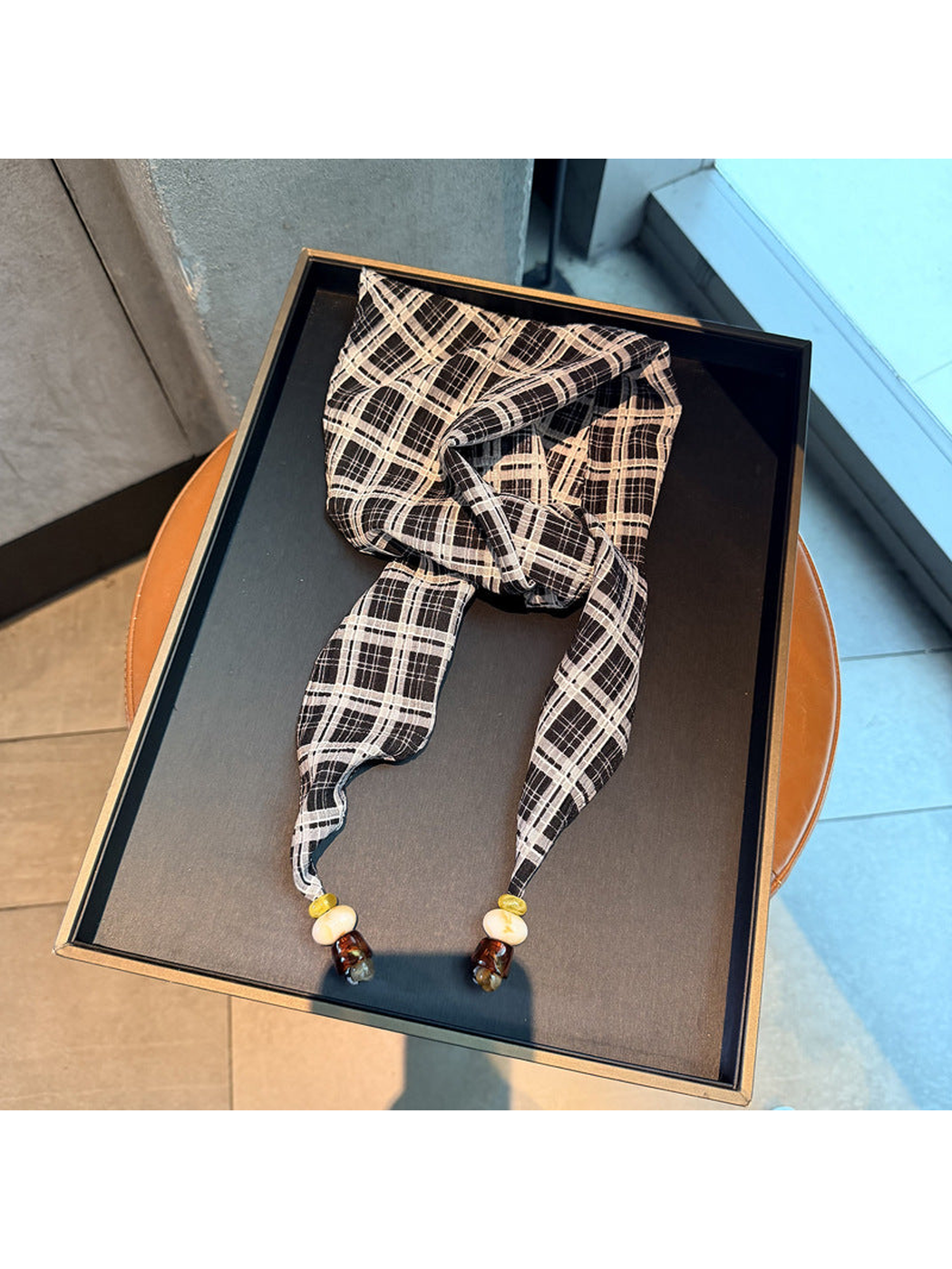 Black plaid scarf with tapered ends and bead accents, full view
