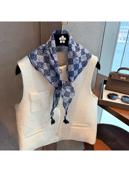 Navy checkerboard floral triangle scarf knotted over a vest