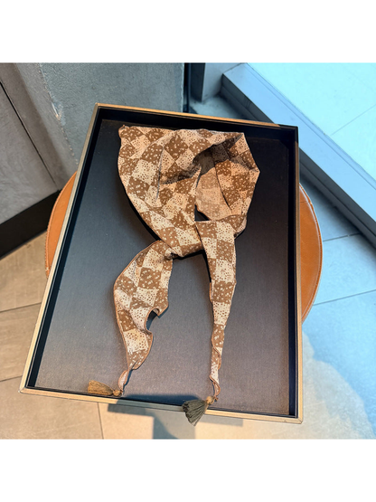 Brown checkerboard floral triangle scarf with tassel ends, tied display