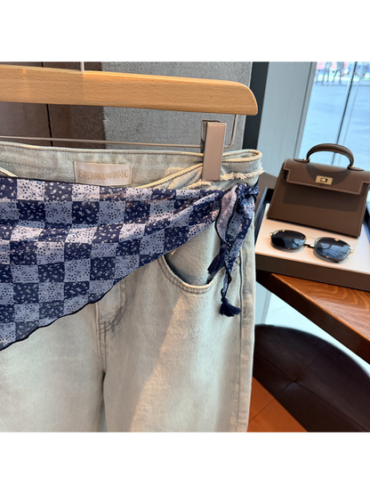 Close-up of the navy scarf waist tie and tassel end