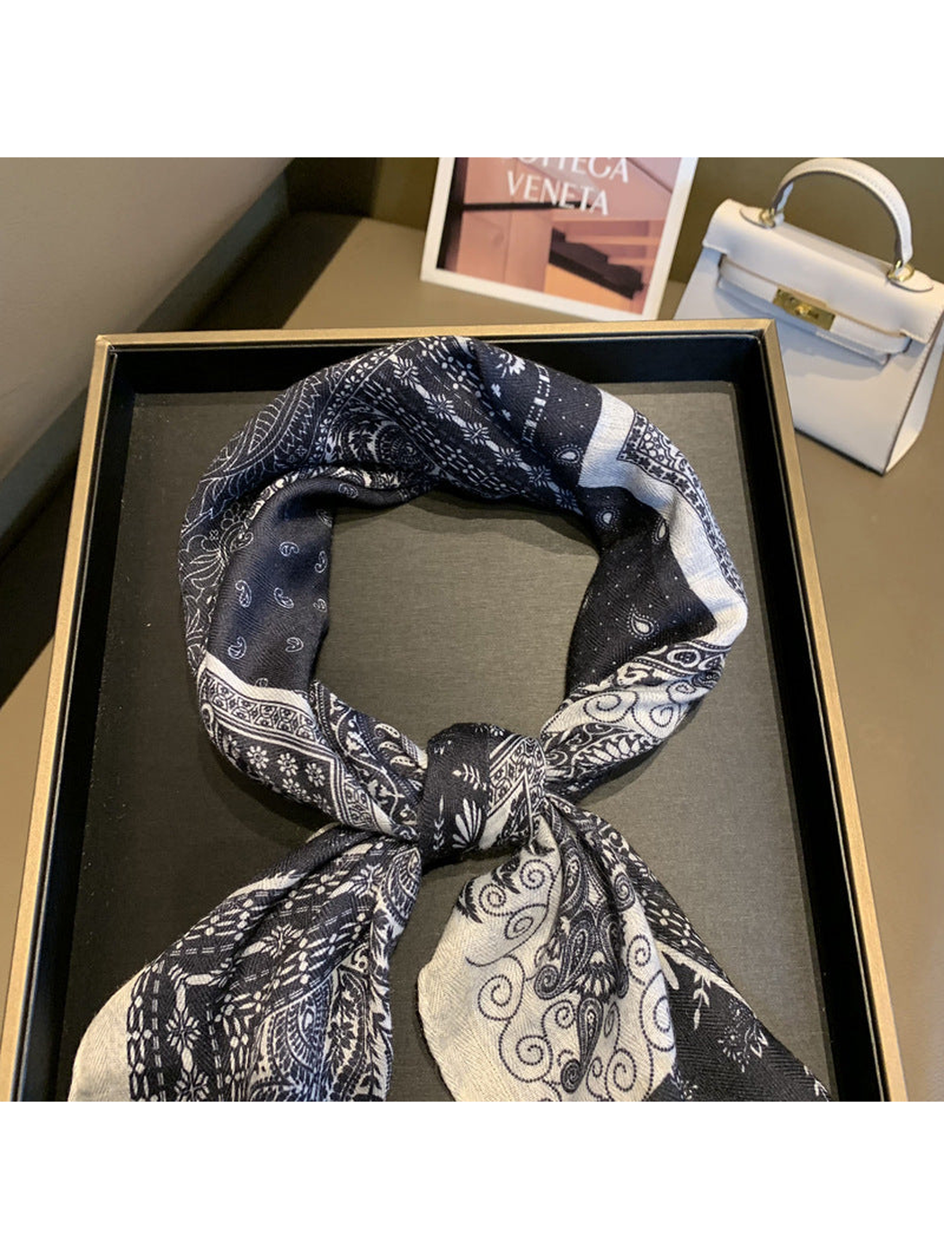Close-up of the knotted navy and ivory patchwork scarf