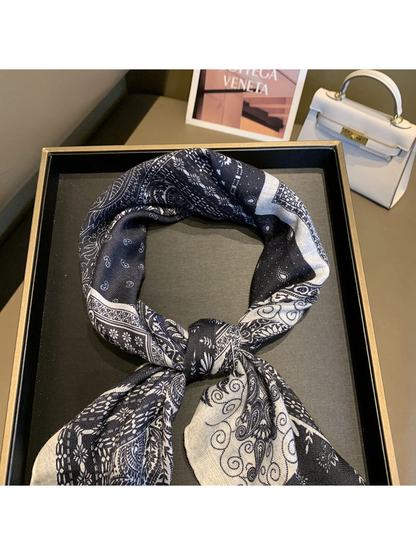 Close-up of the knotted navy and ivory patchwork scarf
