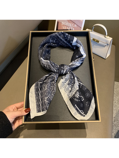 Navy and ivory patchwork scarf styled in a loose knot on a display tray