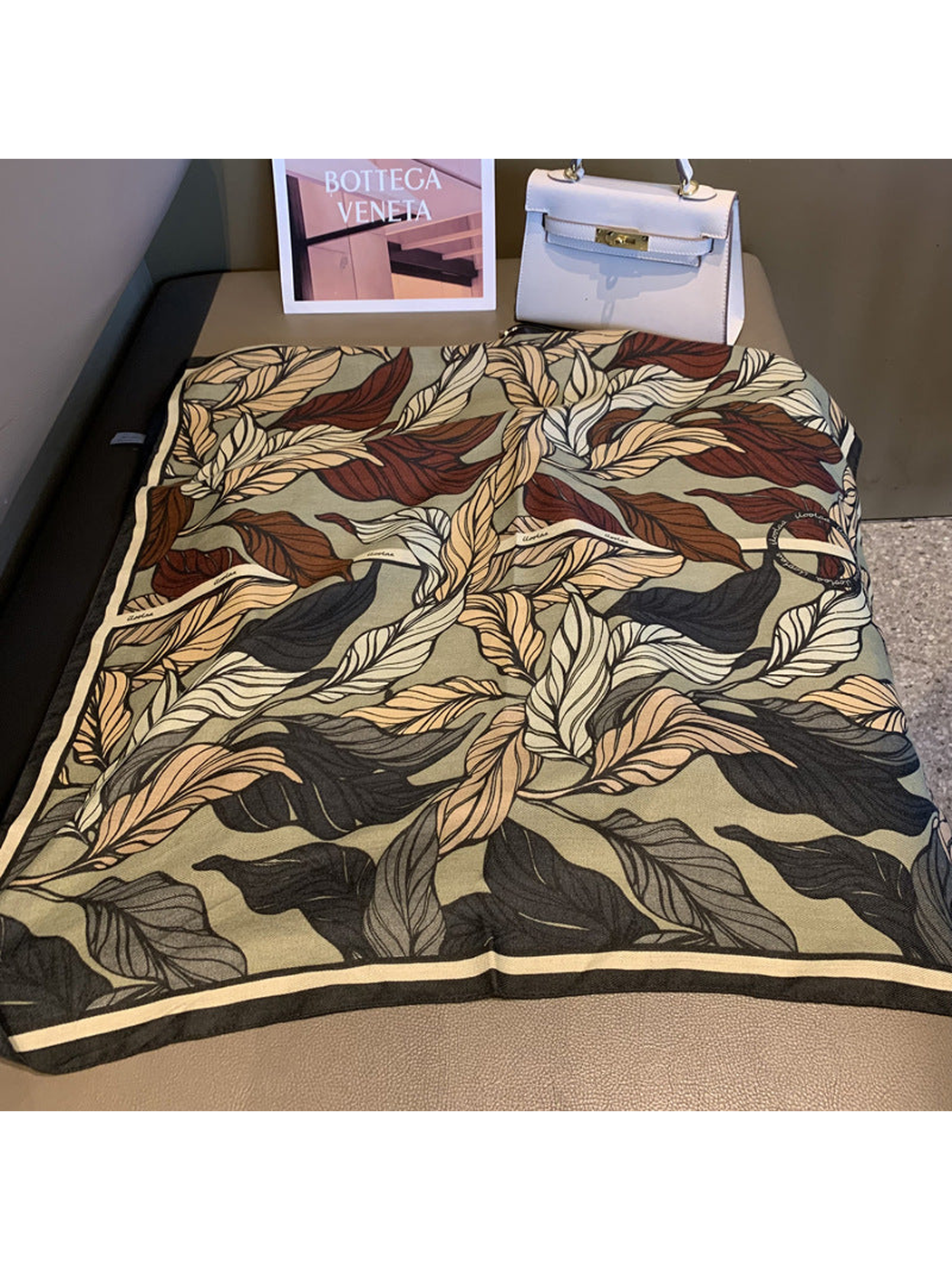 Army Green square scarf with an oversized overlapping leaf print, laid flat