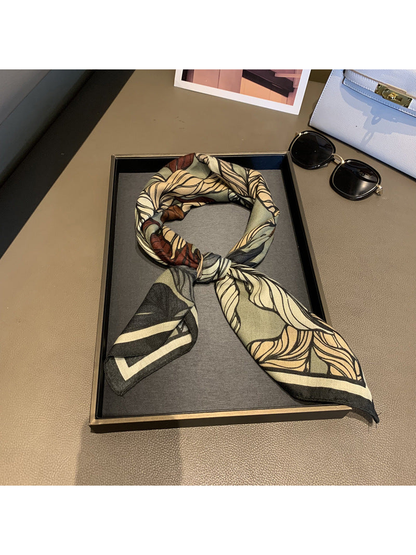 Army Green leaf-print scarf tied in a loop on a display tray