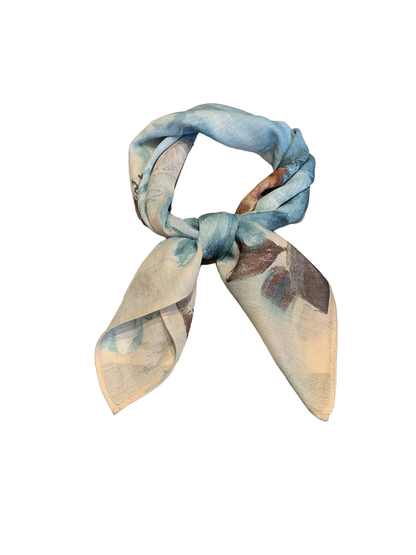 Blue-gray floral square scarf tied in a loose knot with both ends displayed