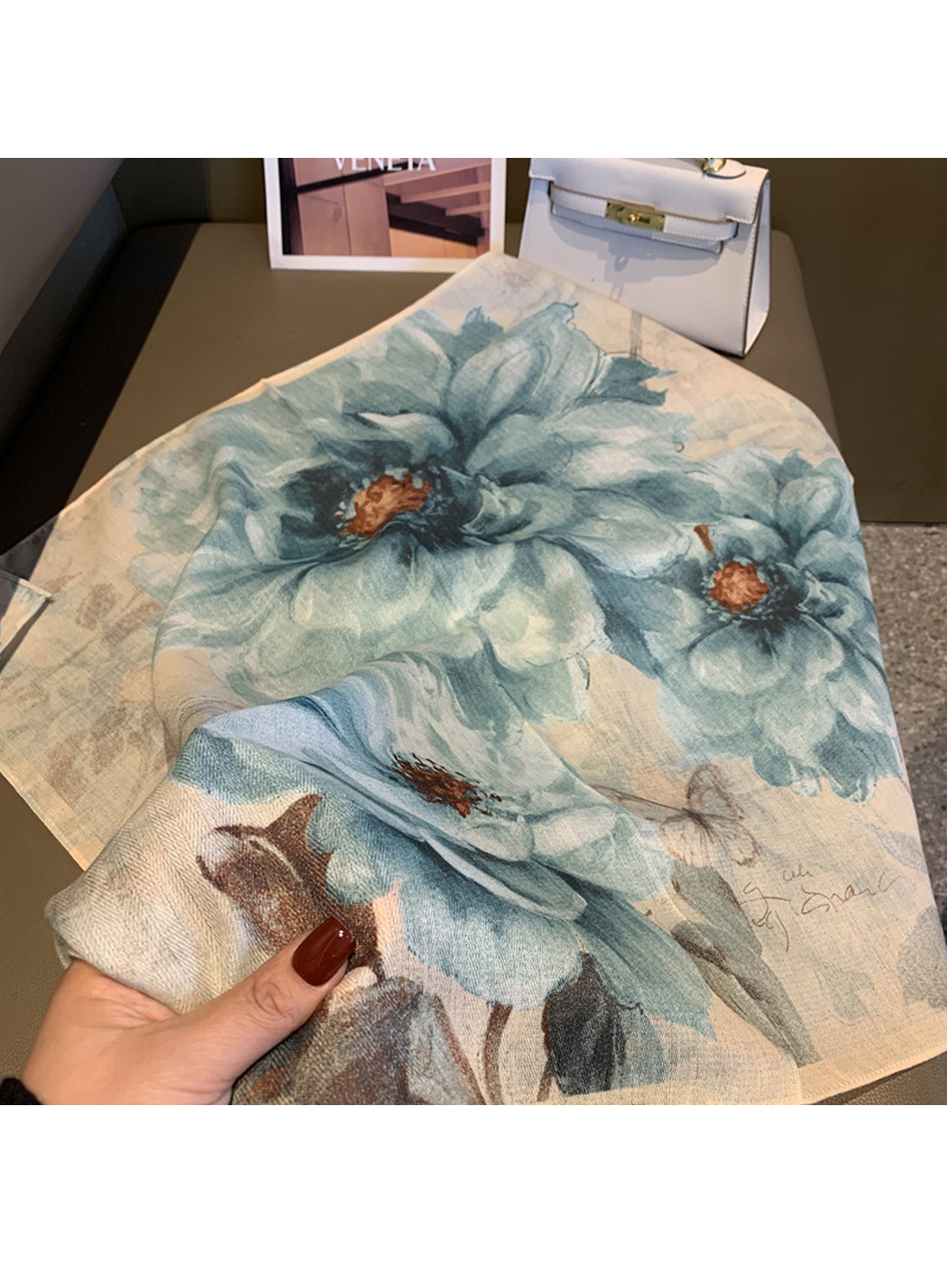 Close-up of the blue-gray floral scarf gathered to show its drape and print
